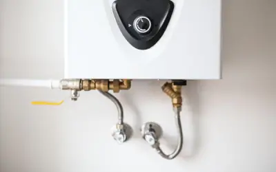 Plumbing connections to a tankless water heater. Knowing the pros and cons of tankless heaters is an important consideration when purchasing.