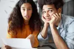 Surprised couple looking at a bill