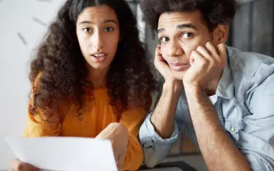 Surprised couple looking at a bill