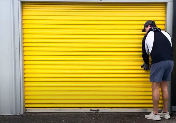 A man opening a storage unit.